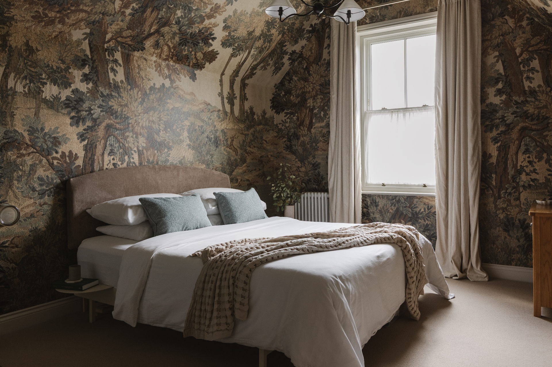 Bedroom with a dramatic woodland mural wallpaper