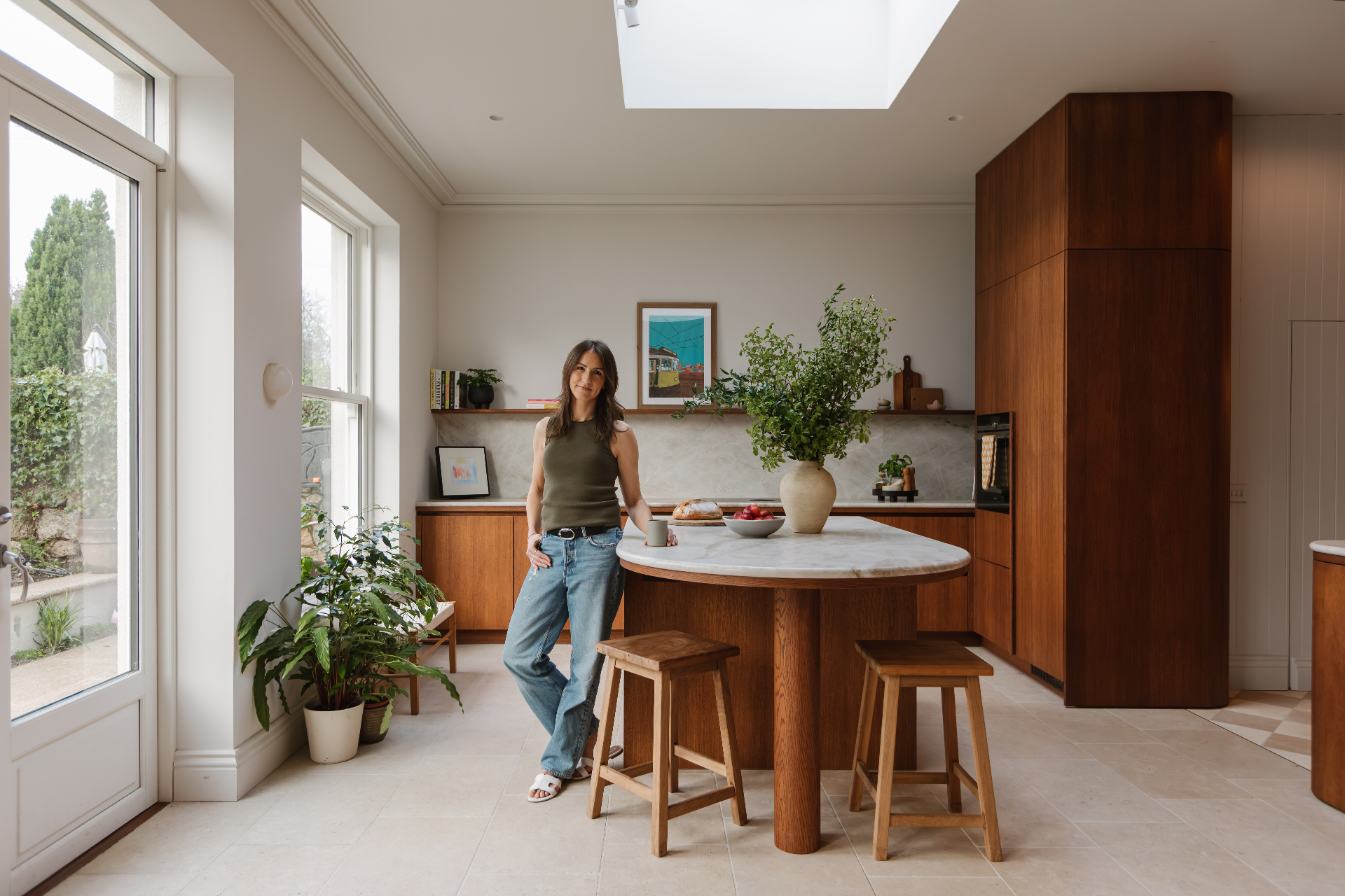 Kate at a walnut kitchen island under a skylight