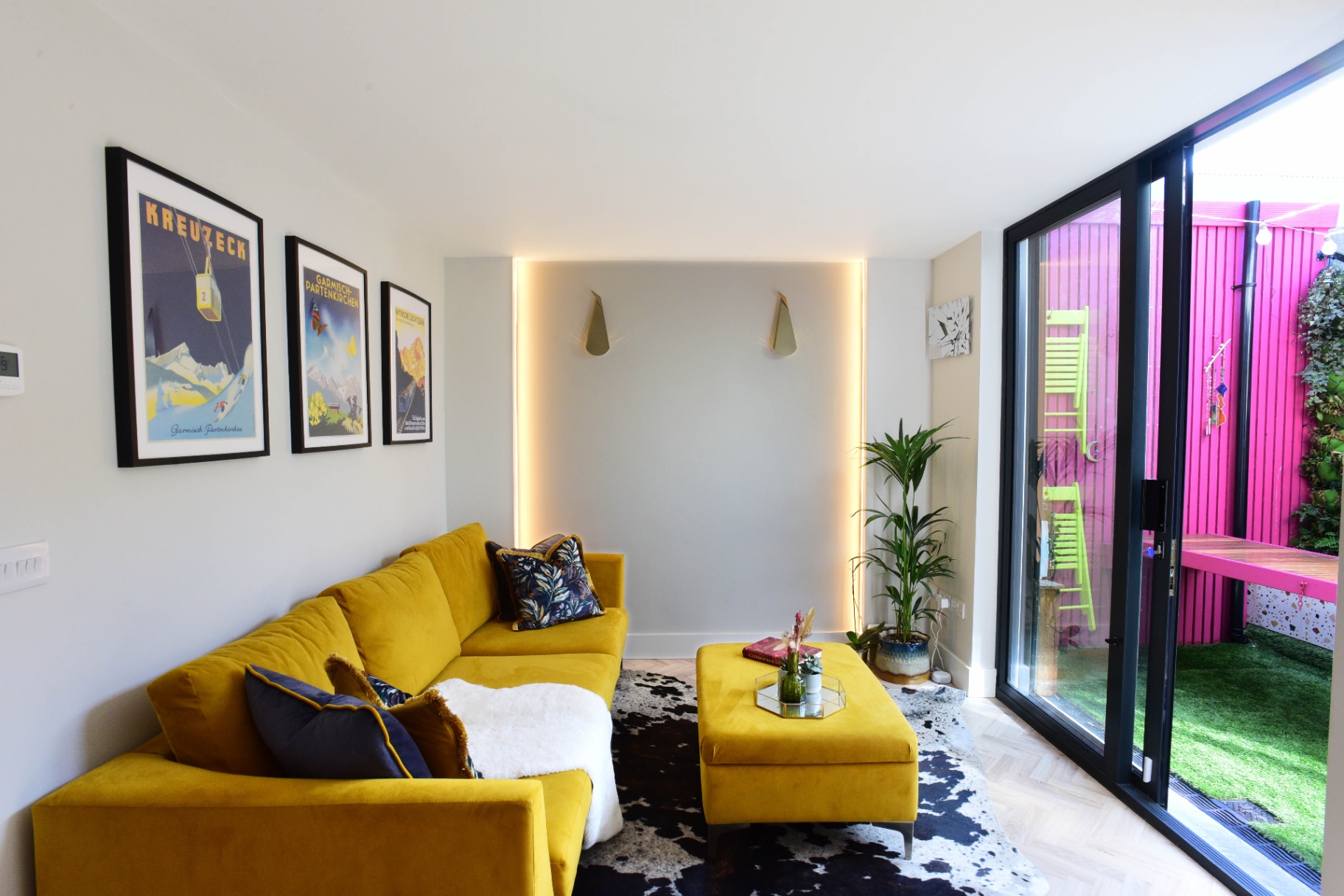Bright living space with a yellow velvet sofa
